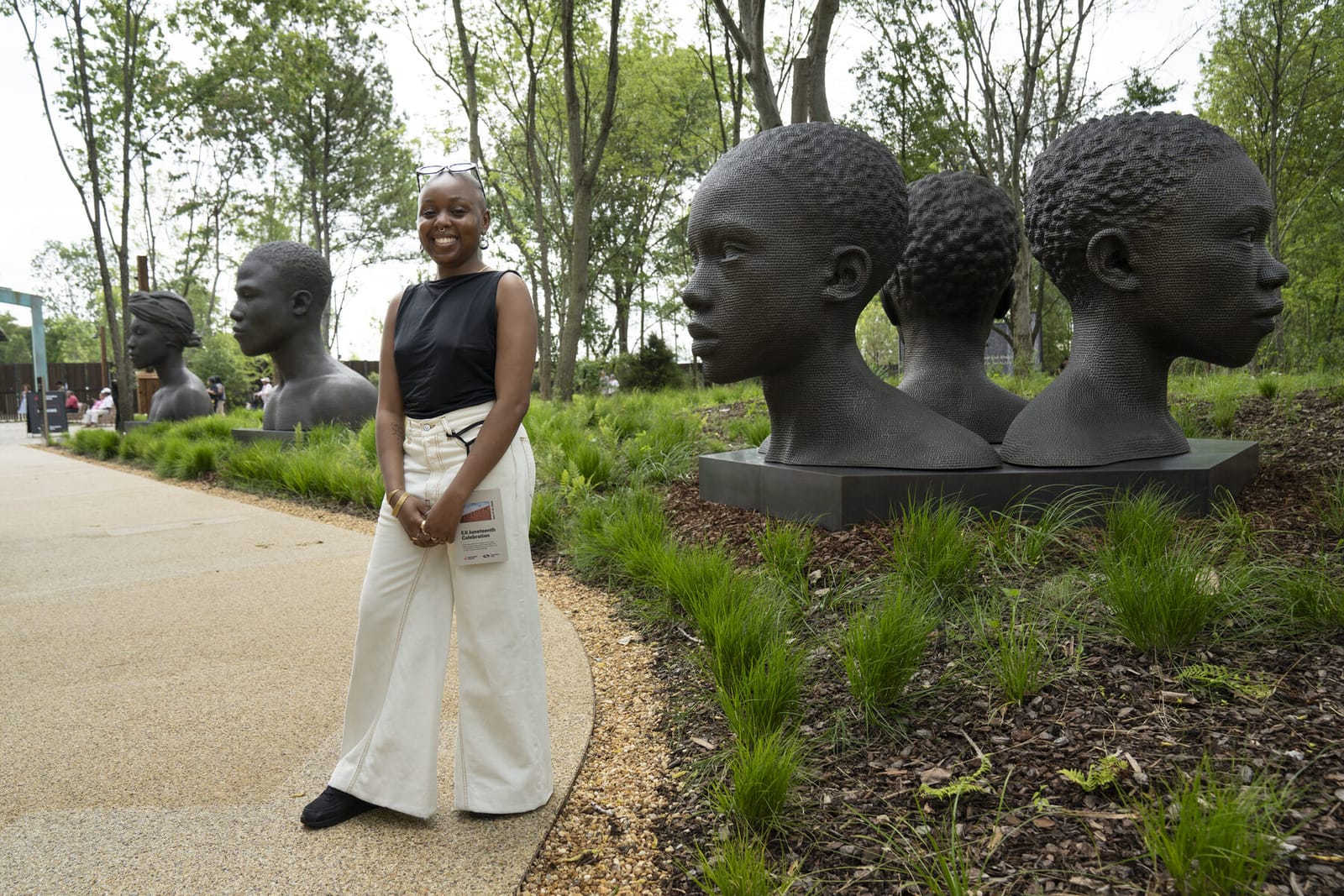 Rayvenn D'Clark alongside her permanent bronze sculptures at the Equal Justice Initiative's Legacy Sites in Montgomery, Alabama, 2024